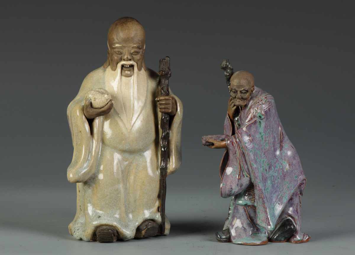 Appraisal: Glazed Oriental Figures L Glazed Figure of a Love god