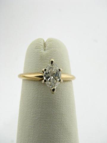 Appraisal: K yellow gold ring with marquis cut diamond center stone