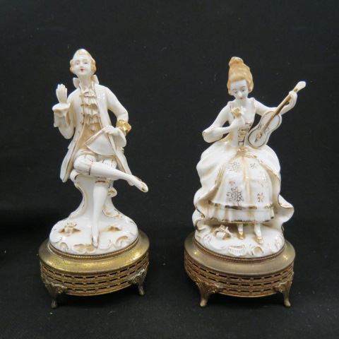 Appraisal: Pair of Porcelian FiguresColonial man and woman brass bases tall