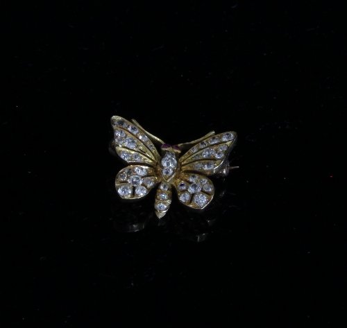 Appraisal: A diamond butterfly brooch with ruby set eyes one stone