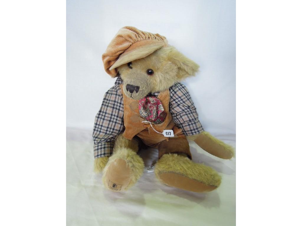 Appraisal: A teddy bear wearing a check shirt felt cap and