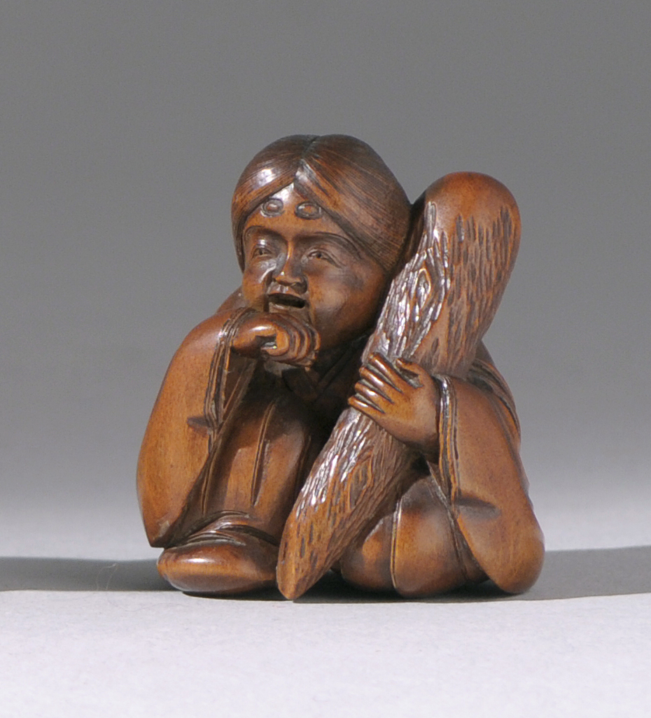 Appraisal: WOOD NETSUKE th CenturyDepicting Okame seated holding a large club