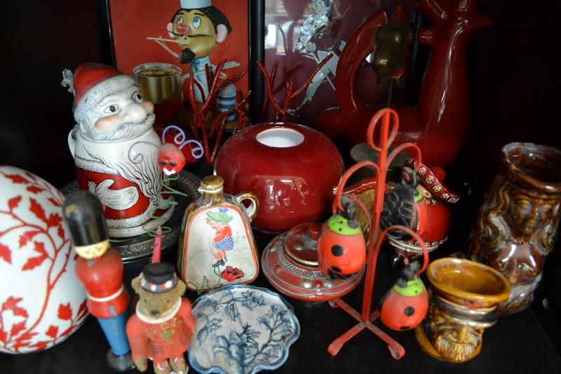 Appraisal: SHELF OF RED ITEMS INCL ART GLASS FIGURINES FRAMED PRINTS