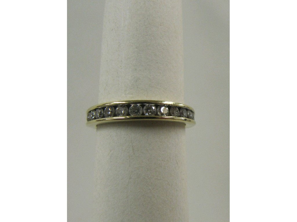 Appraisal: Fourteen carat gold channel set diamond half hoop ring