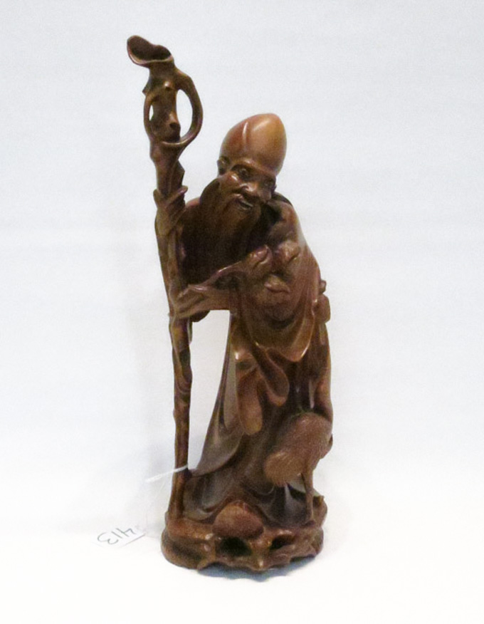 Appraisal: CHINESE CARVED HARDWOOD FIGURE of a male elder holding a