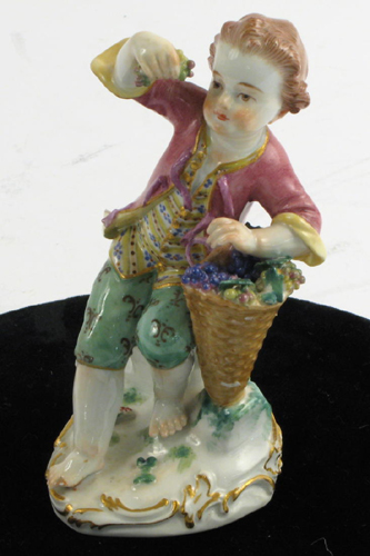 Appraisal: MEISSEN PORCELAIN FIGURE barefoot boy holding aloft grapes from his