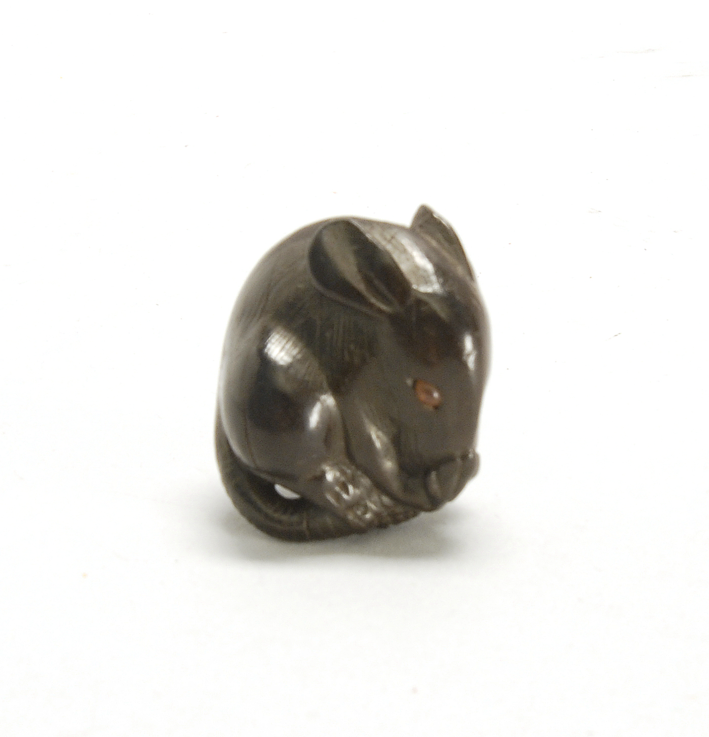 Appraisal: WOOD NETSUKE th CenturyIn the form of a curled rat