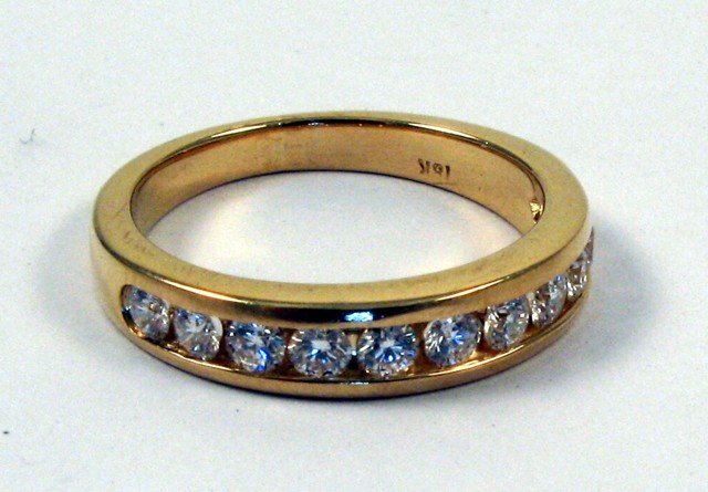 Appraisal: DIAMOND AND FOURTEEN KARAT GOLD RING set with eleven round-cut