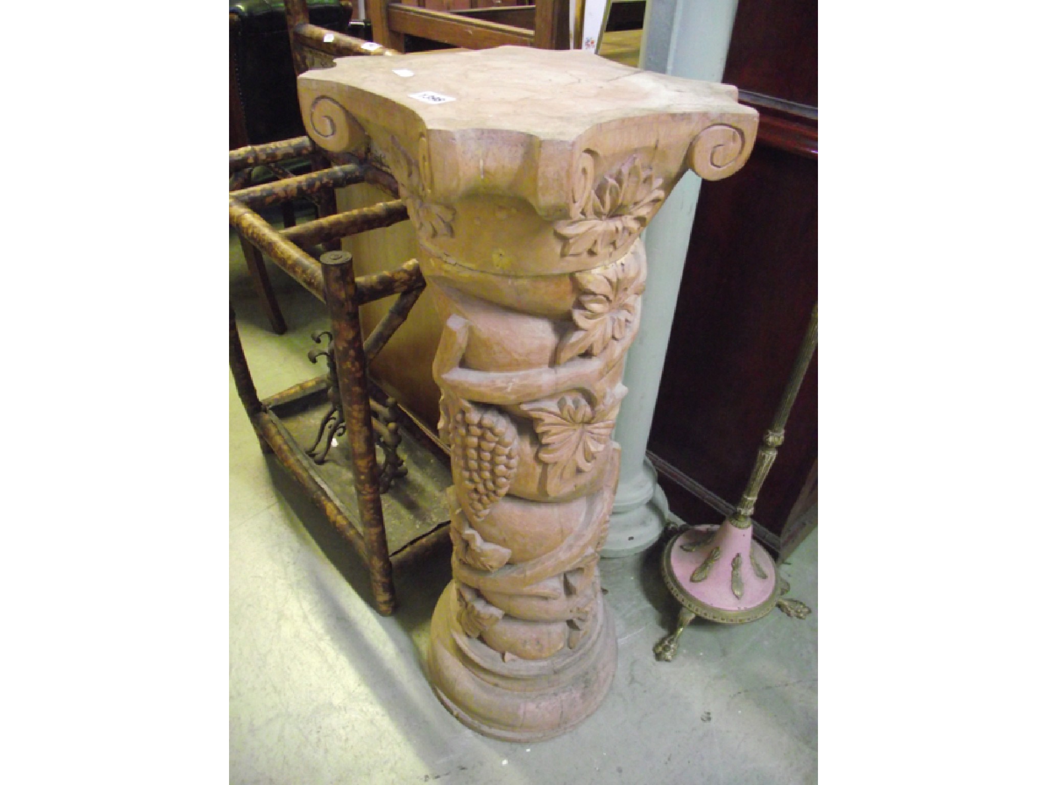 Appraisal: A carved hardwood pedestal of spiral form with vine leaf