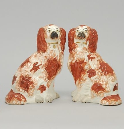 Appraisal: PAIR OF STAFFORDSHIRE SPANIELS Circa In rust-red and white with