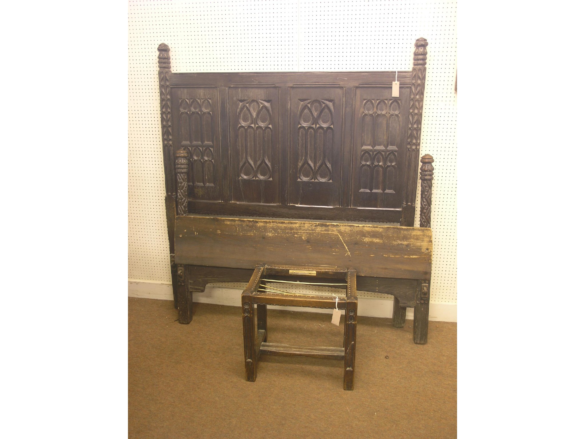 Appraisal: A th century-style dark oak bedstead headboard with gothic tracery