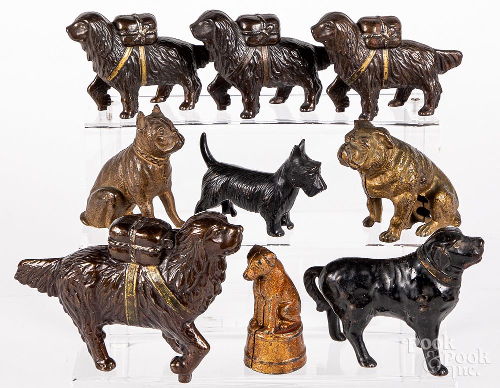 Appraisal: Nine cast iron dog still bank Nine cast iron dog