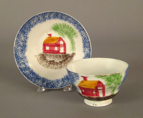 Appraisal: Blue spatter cup and saucer th c with schoolhouse decoration