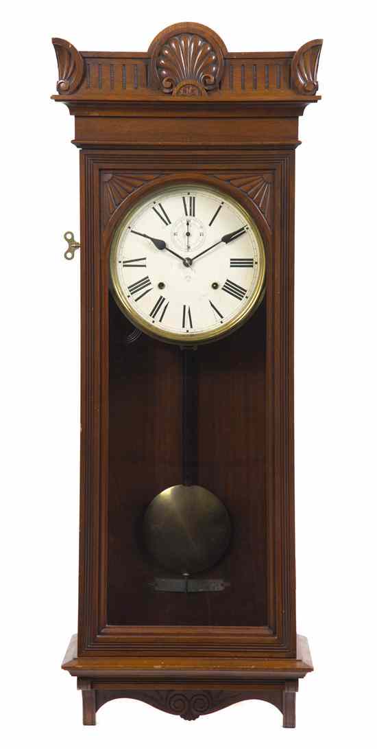 Appraisal: A Victorian Walnut Wall Clock Ansonia having a shell and