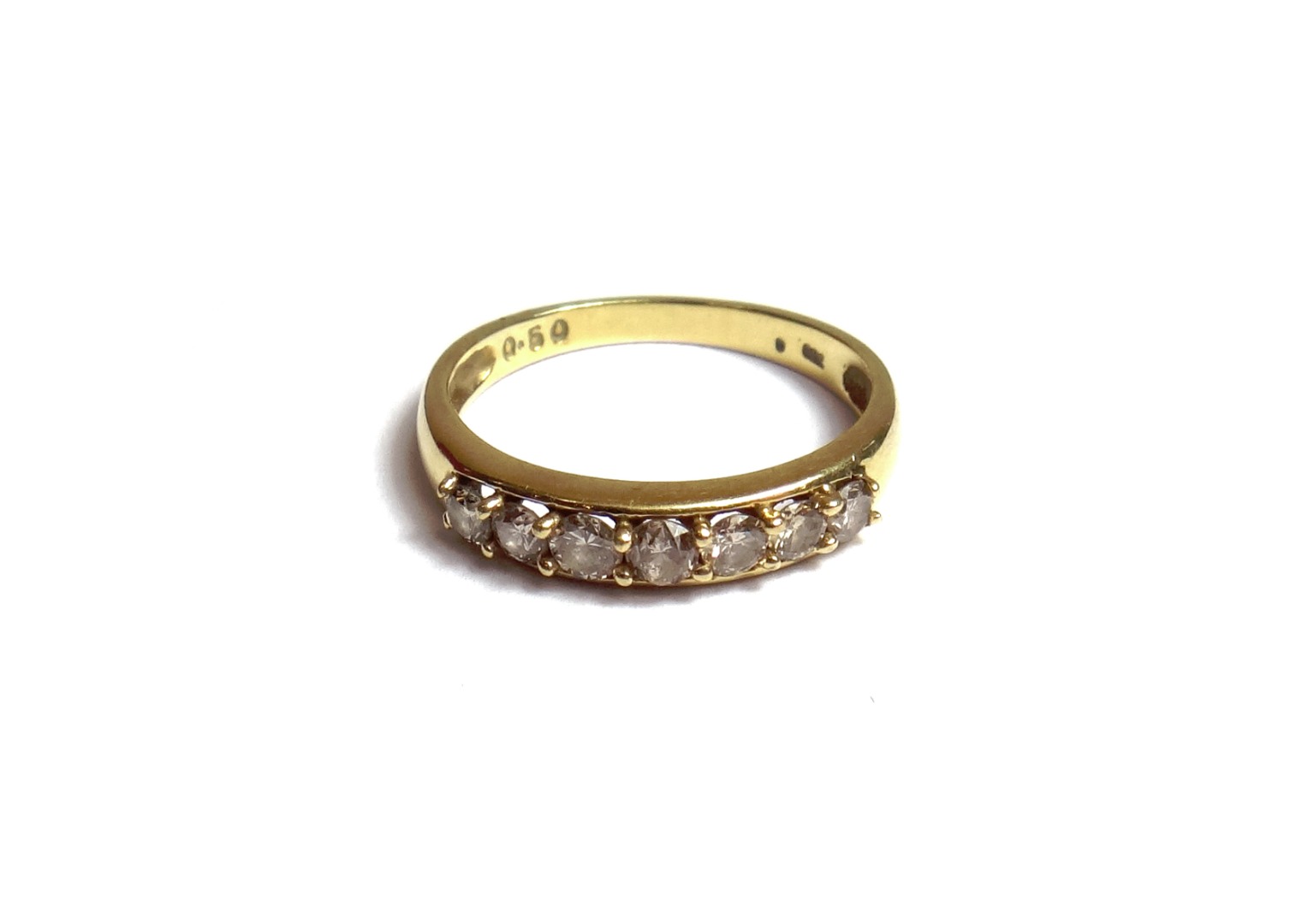 Appraisal: A gold and diamond set seven stone half hoop ring