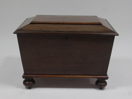 Appraisal: A th Century mahogany sarcophagus shaped cellaret with fitted interior