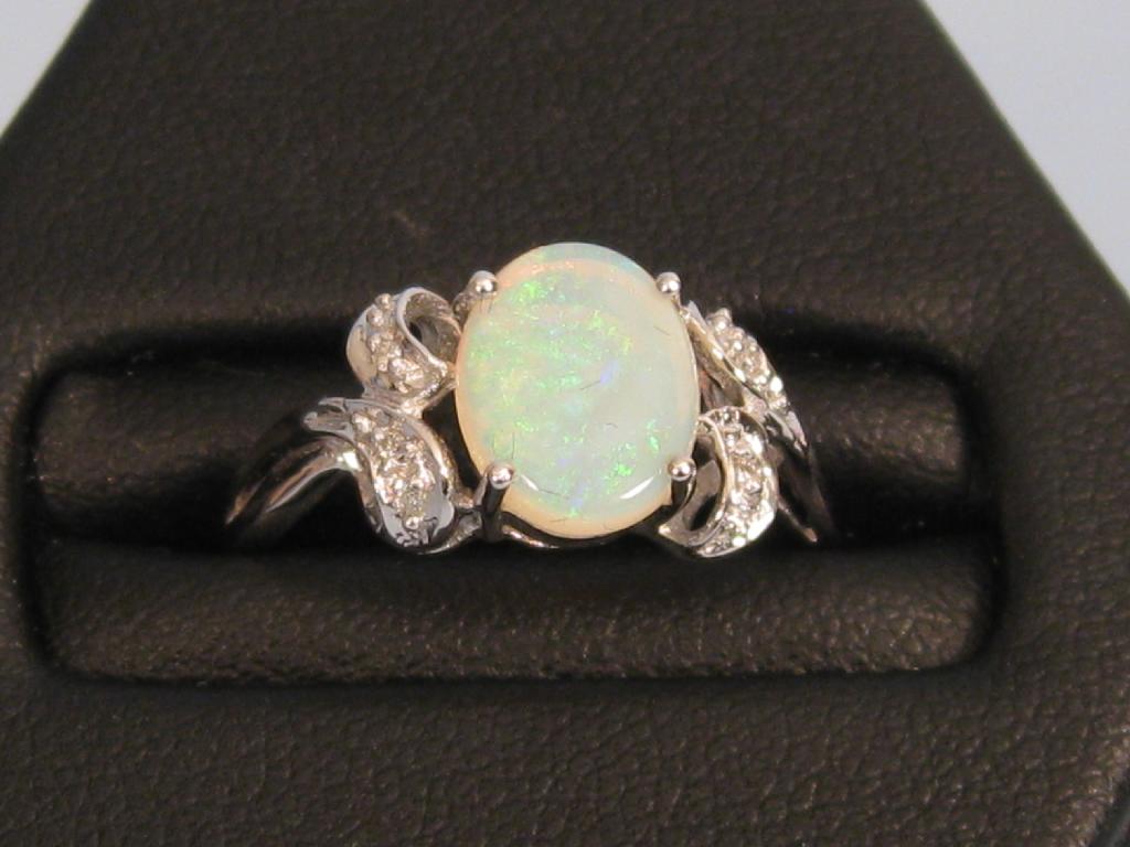 Appraisal: A Continental Opal and Diamond Ring the cabochon opal claw-set