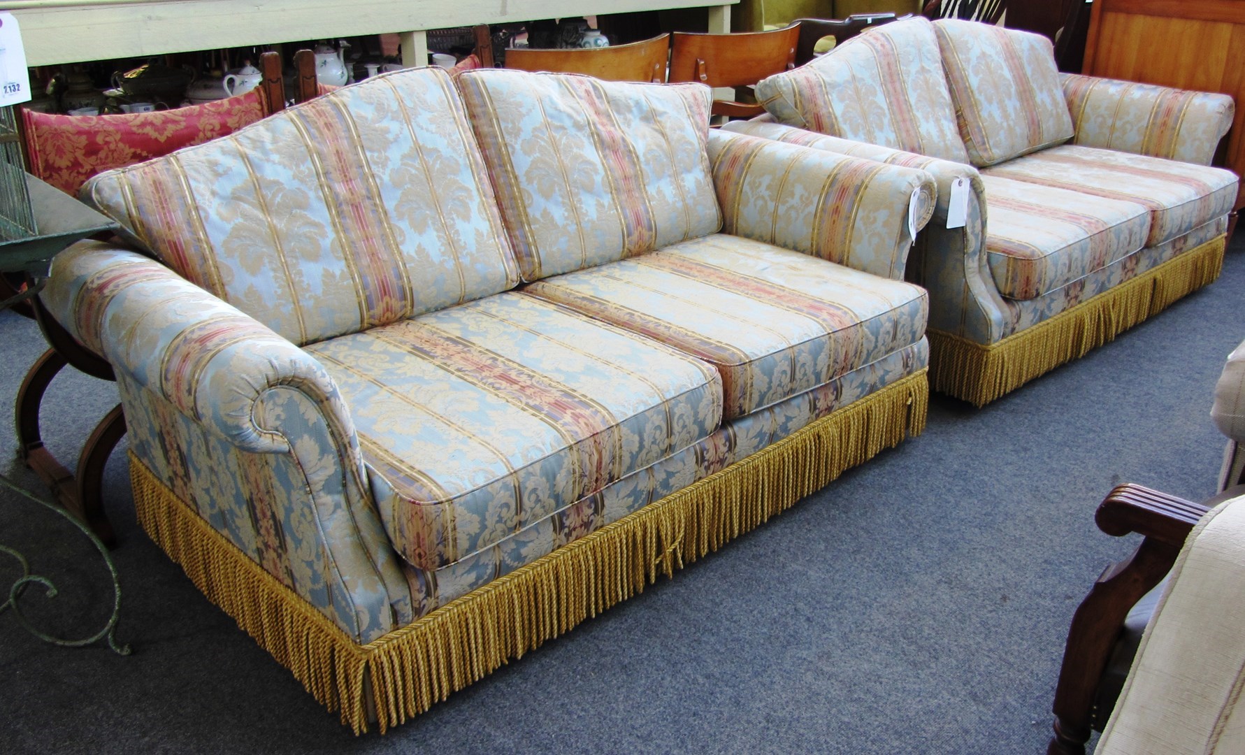 Appraisal: A pair of th century two seat sofas upholstered in