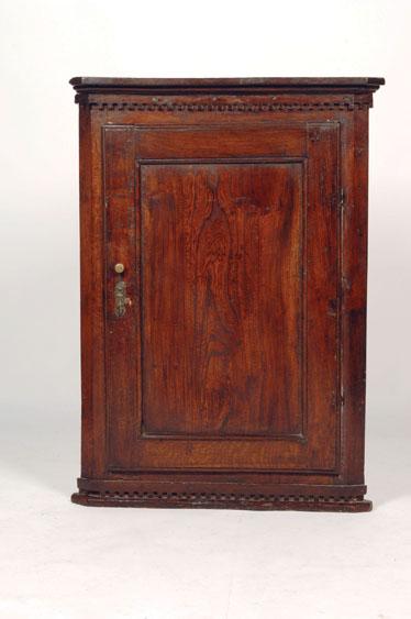 Appraisal: A GEORGE III OAK HANGING CORNER CUPBOARD with a dentil