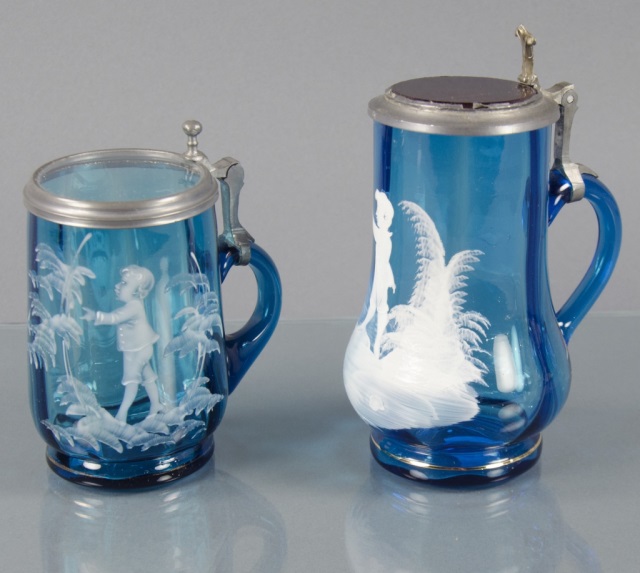 Appraisal: Two Blue Mary Gregory SteinsEach decorated with white enamel scenes