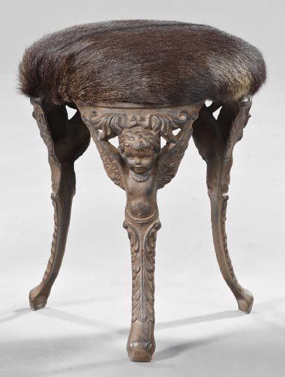 Appraisal: Belle Epoque Cast-Iron Winged Putto Masque Tripodal Stool first quarter