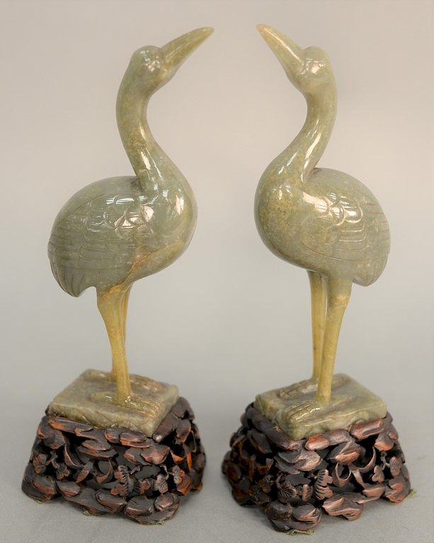 Appraisal: Pair of Chinese green gray jade cranes having raised head