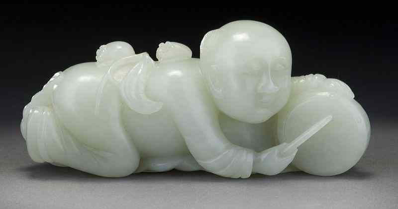 Appraisal: Chinese carved white jade statuedepicting a boy striking a drum