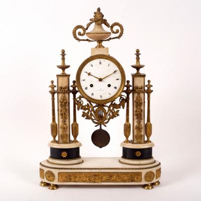 Appraisal: A French gilt metal mounted portico clock the enamel dial