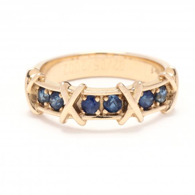 Appraisal: Gold and Sapphire Ring Ring with repeating X motifs set