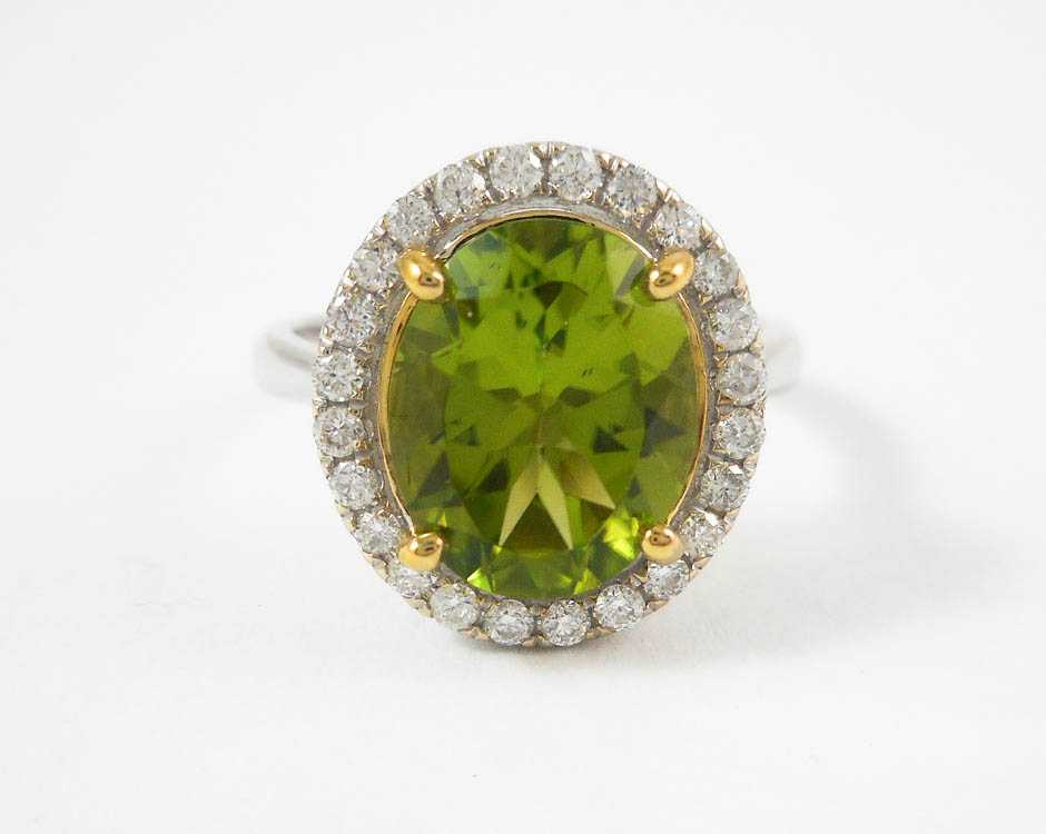 Appraisal: PERIDOT DIAMOND AND FOURTEEN KARAT GOLD RING The white gold