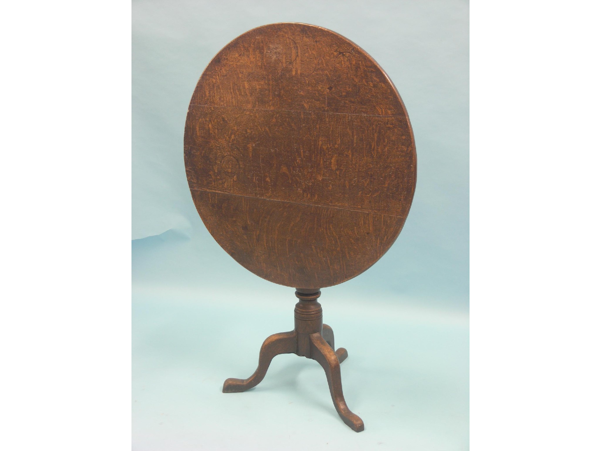 Appraisal: A George III oak tilt-top tripod table circular top on