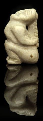 Appraisal: Northwest Coast witch stone carving the figure bound tightly by