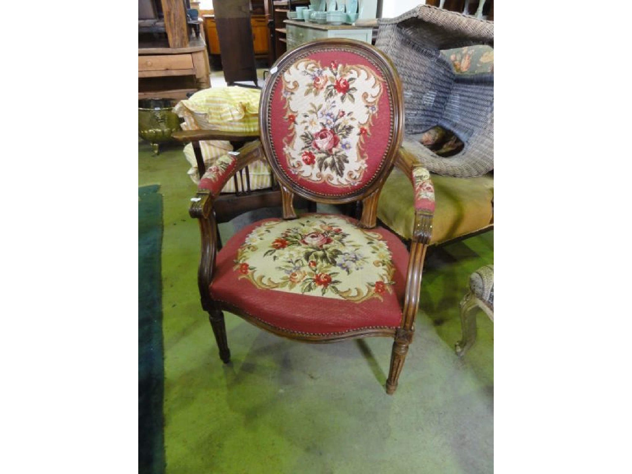 Appraisal: A French style open armchair with floral tapestry upholstered serpentine