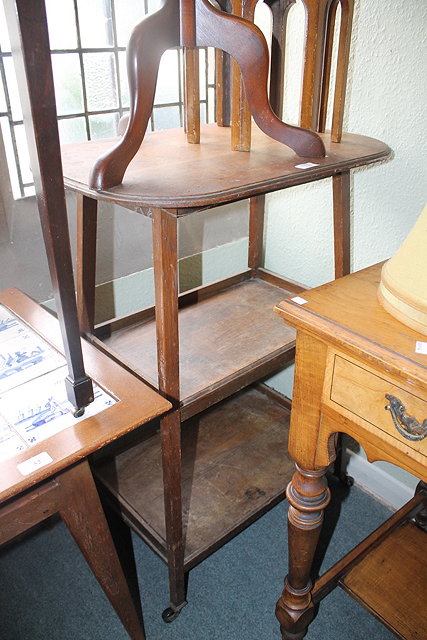 Appraisal: AN EDWARDIAN OAK THREE TIER OCCASIONAL TABLE with oval top