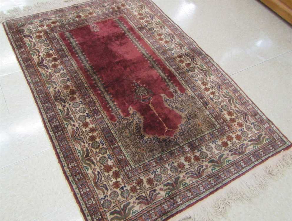 Appraisal: TURKISH PRAYER RUG featuring a burgundy prayer mehrab with image