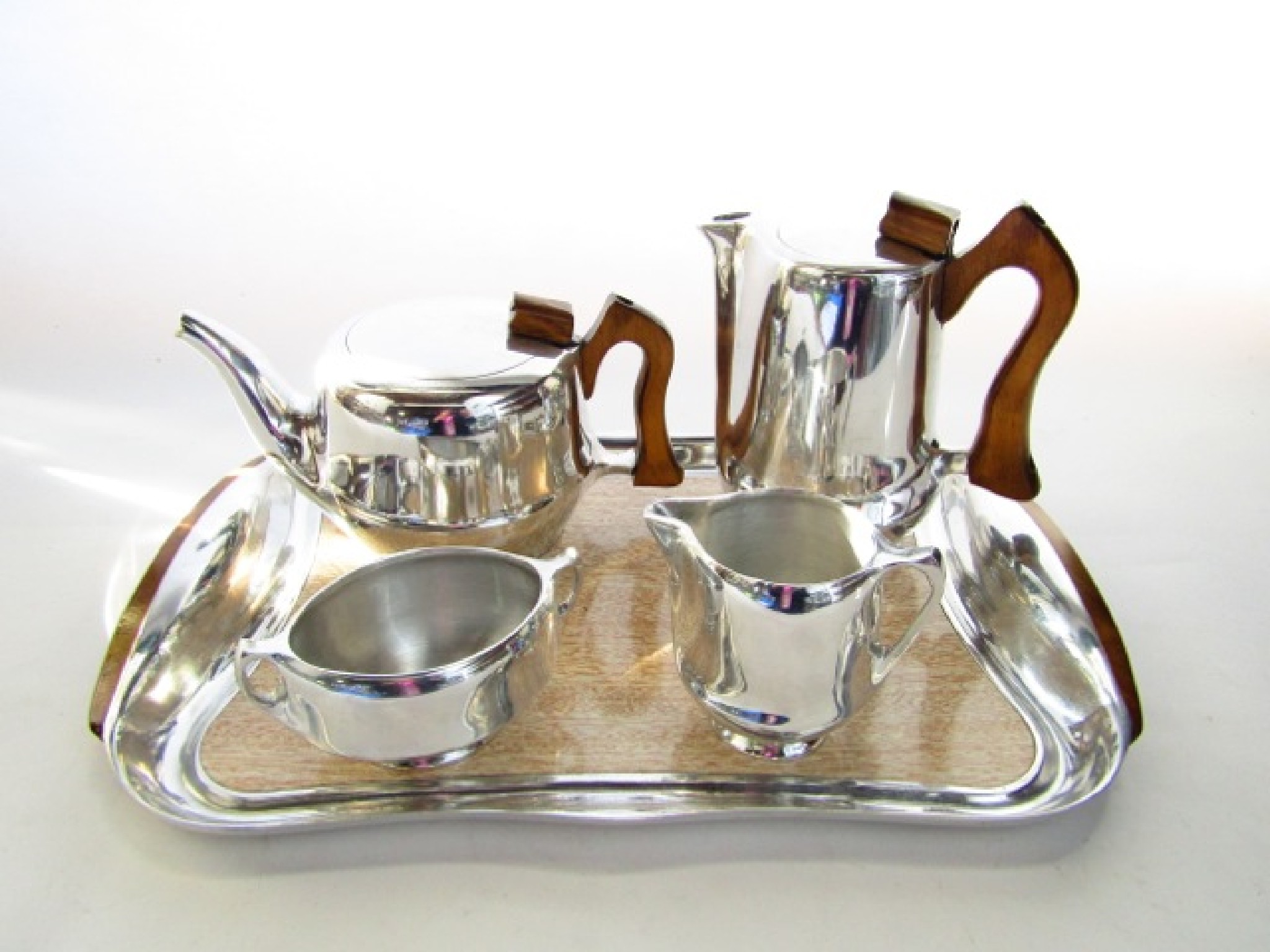 Appraisal: A five piece Piquot ware tea set comprising teapot hot