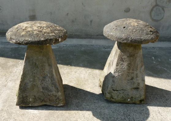 Appraisal: A PAIR OF WEATHERED COMPOSITION STADDLE STONES the mushroom shaped