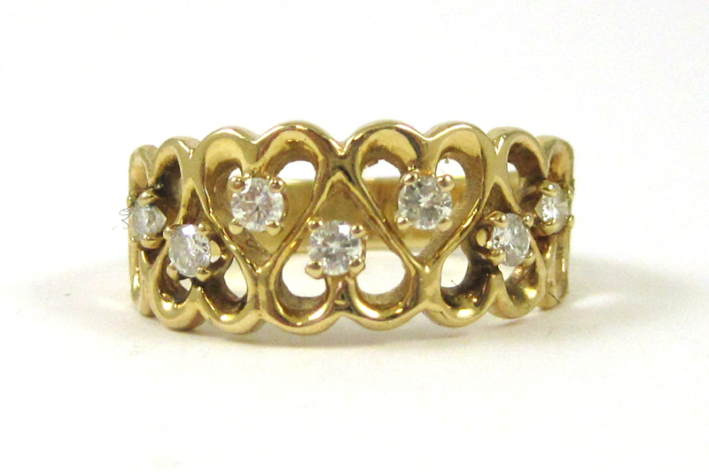 Appraisal: DIAMOND AND FOURTEEN KARAT GOLD RING The yellow gold heart