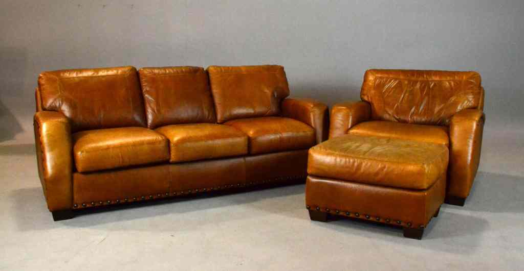 Appraisal: Pcs Robinson Leather Couch Chair OttomanConsisting of natural leather rustic-style