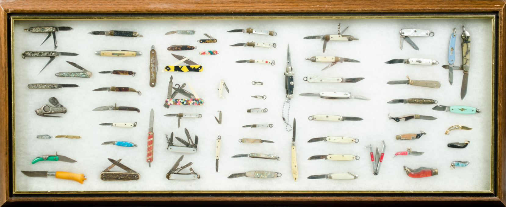 Appraisal: FRAME OF SIXTY SIX MINIATURE FOLDING POCKET KNIVES sizes from