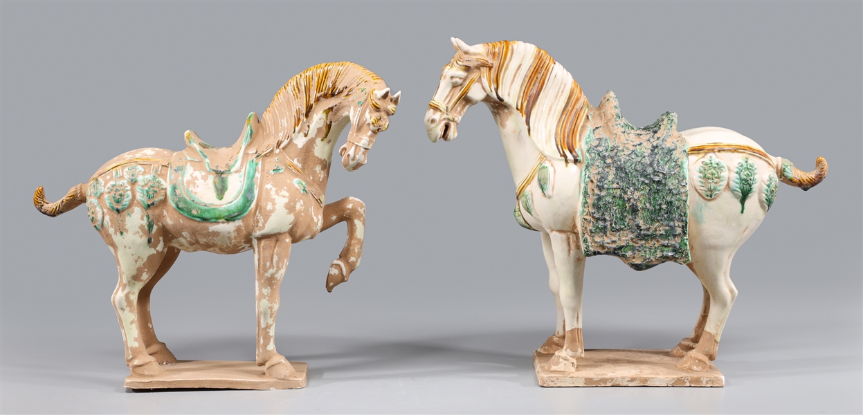 Appraisal: Two Chinese spinach and egg glazed pottery horses each elaborately