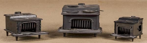 Appraisal: Three cast iron toy stoves largest - '' h Three