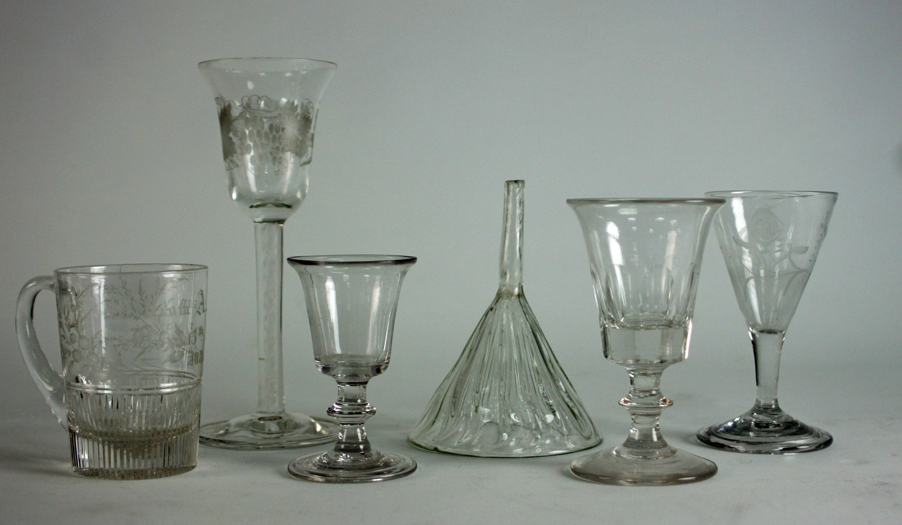 Appraisal: A cordial glass the inverted bell-shaped bowl on an airtwist