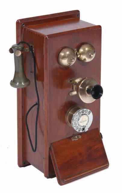 Appraisal: AN OLD MAHOGANY CASED WALL MOUNTED TELEPHONE with bakelite earpiece