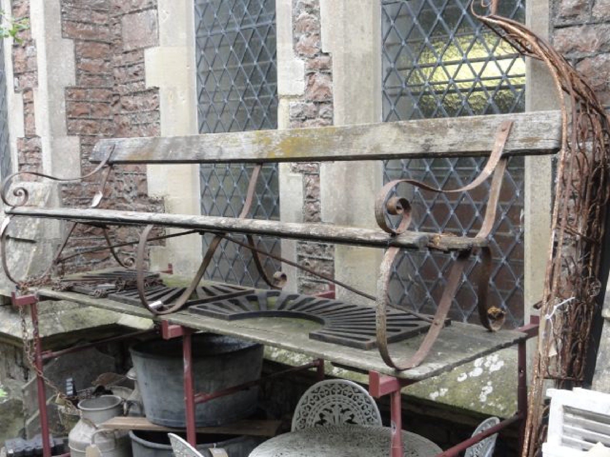 Appraisal: A large sprung steel framed platform bench with weathered timbered