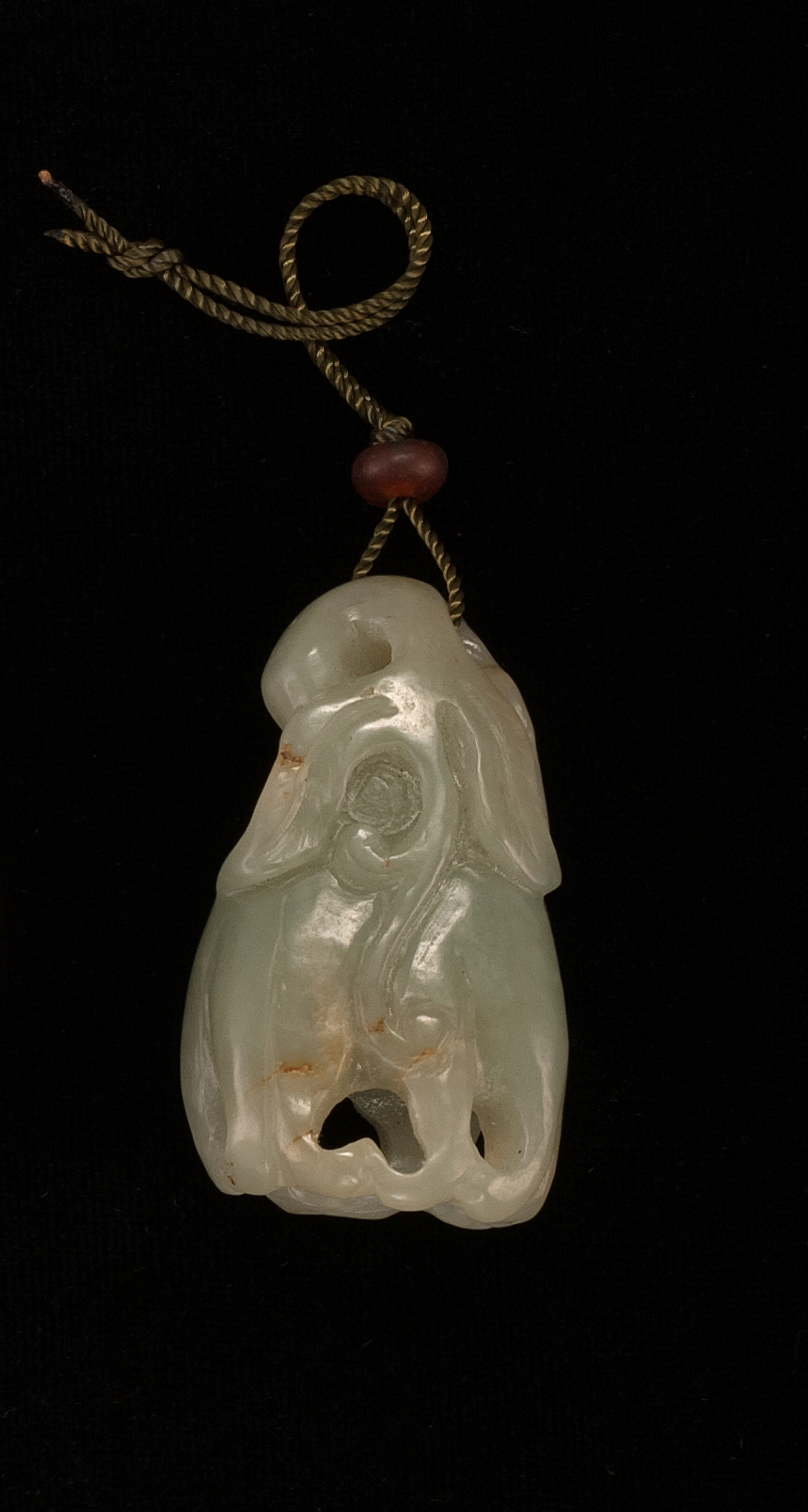 Appraisal: CELADON AND RUSSET JADE PENDANT th CenturyIn Buddha's hand fruit