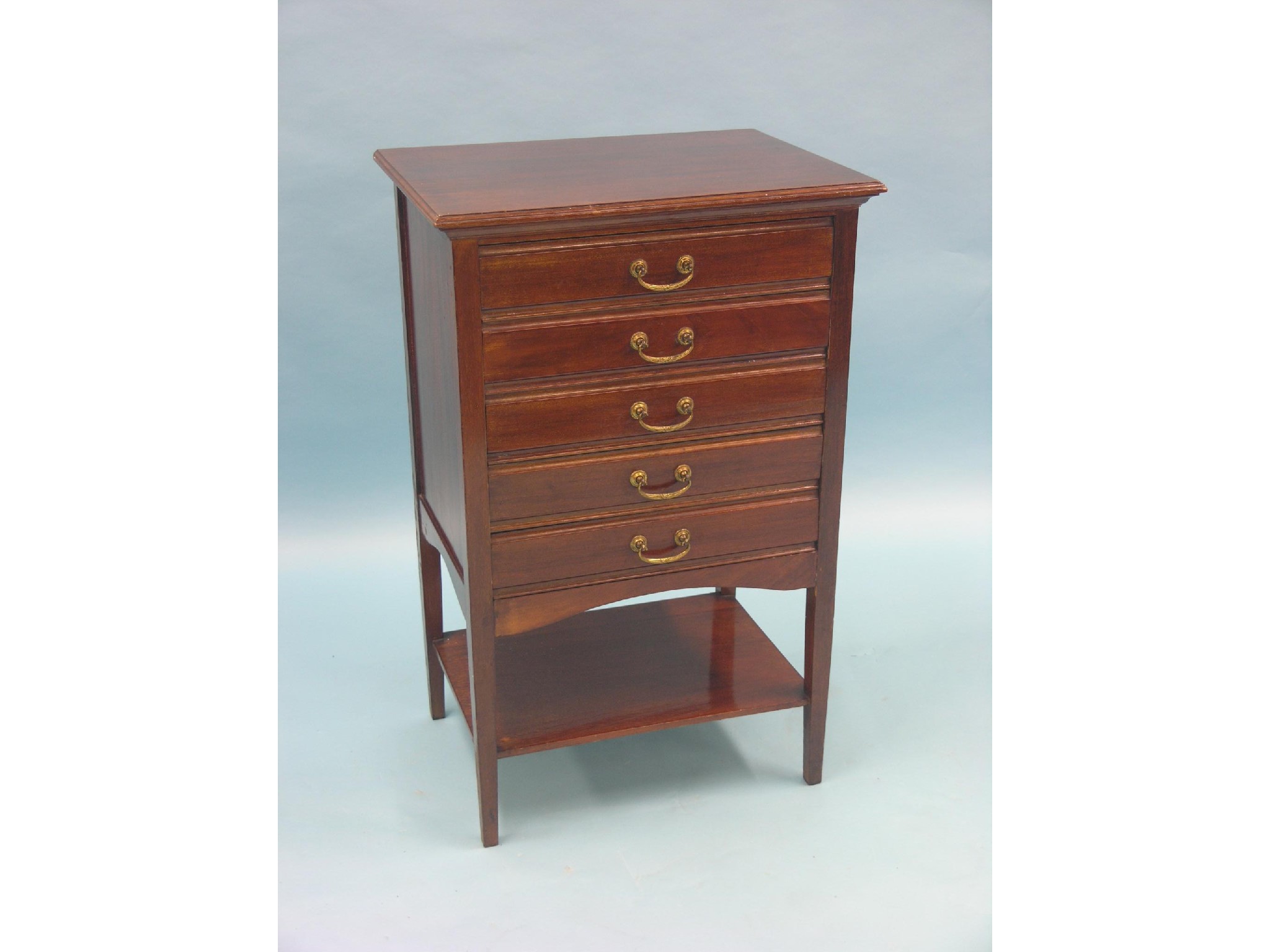 Appraisal: An early th century mahogany music chest five fall-front drawers