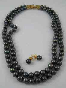 Appraisal: A grey cultured pearl two row necklace with yellow metal