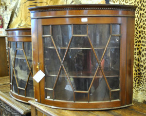 Appraisal: A pair of Victorian mahogany bowfront hanging corner cupboards with