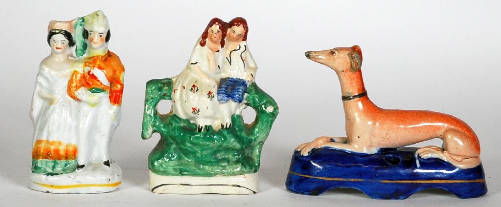 Appraisal: STAFFORDSHIRE RECUMBENT GREYHOUND POTTERY PEN HOLDER painted in colours and